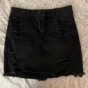 Black stretch jean skirt with rips.
